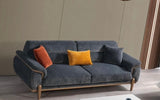 Gray sofa with colorful cushions .
 love seat